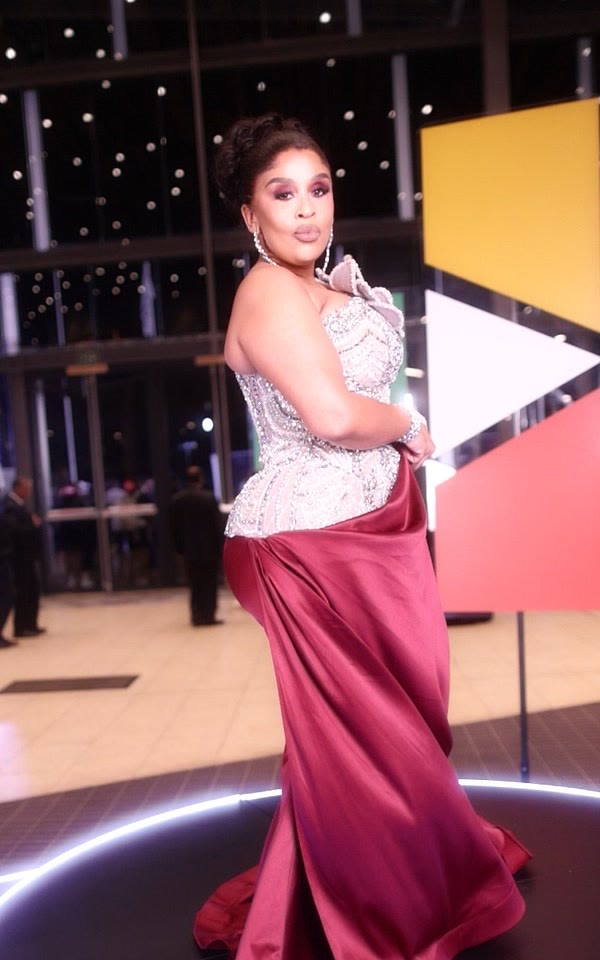 Guest in a burgundy and silver gown on the GlamBot® red carpet