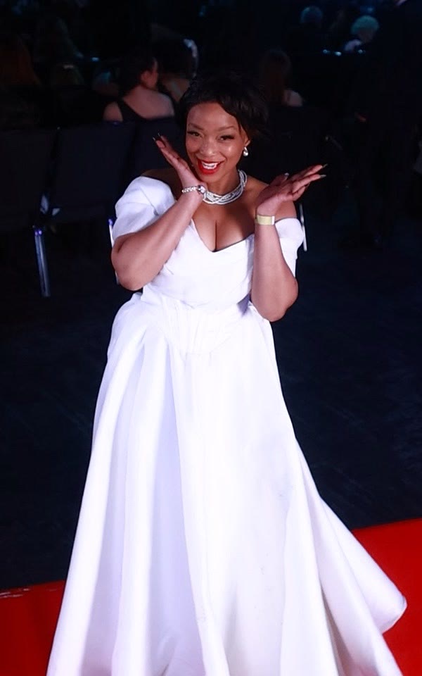 Guest in a white ball gown on the GlamBot® red carpet