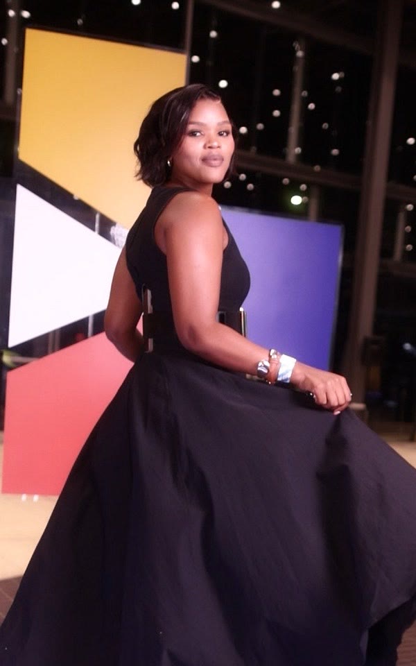Guest in a black ball gown on the GlamBot® red carpet