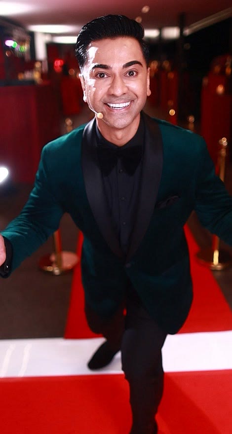 Guest in a green velvet tuxedo on the GlamBot® red carpet